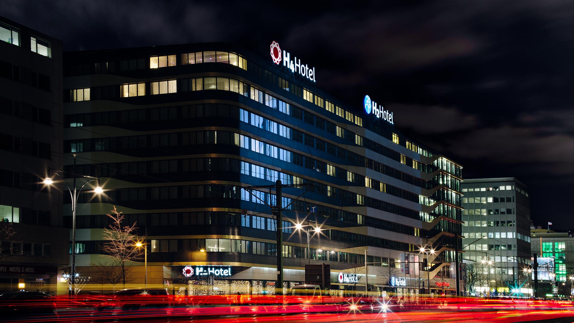 Außenansicht des H4 und H+ Hotels am Alexanderplatz bei Nacht